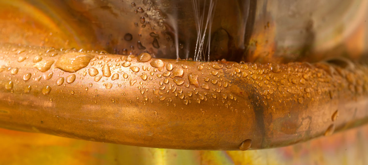 Water leaking from a copper water pipe