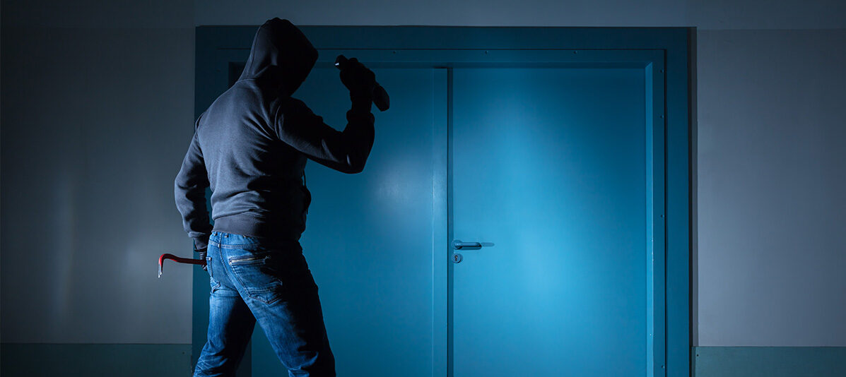 Burglar standing in front of commercial building