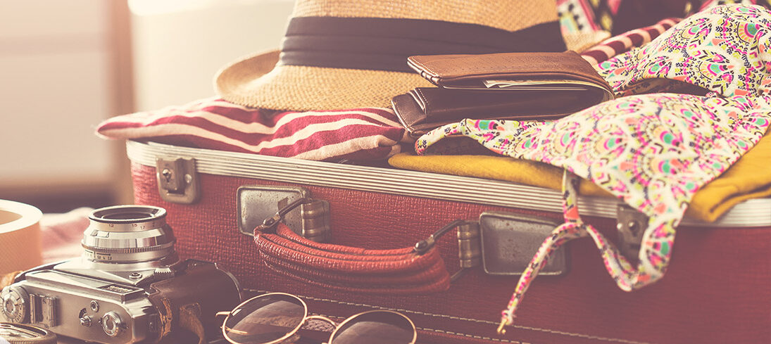 Suitcase with summer travel items.