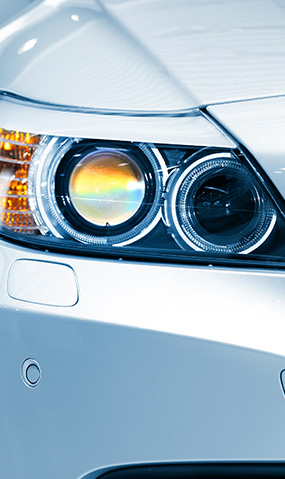 Closeup of a luxury sport vehicle's headlight.