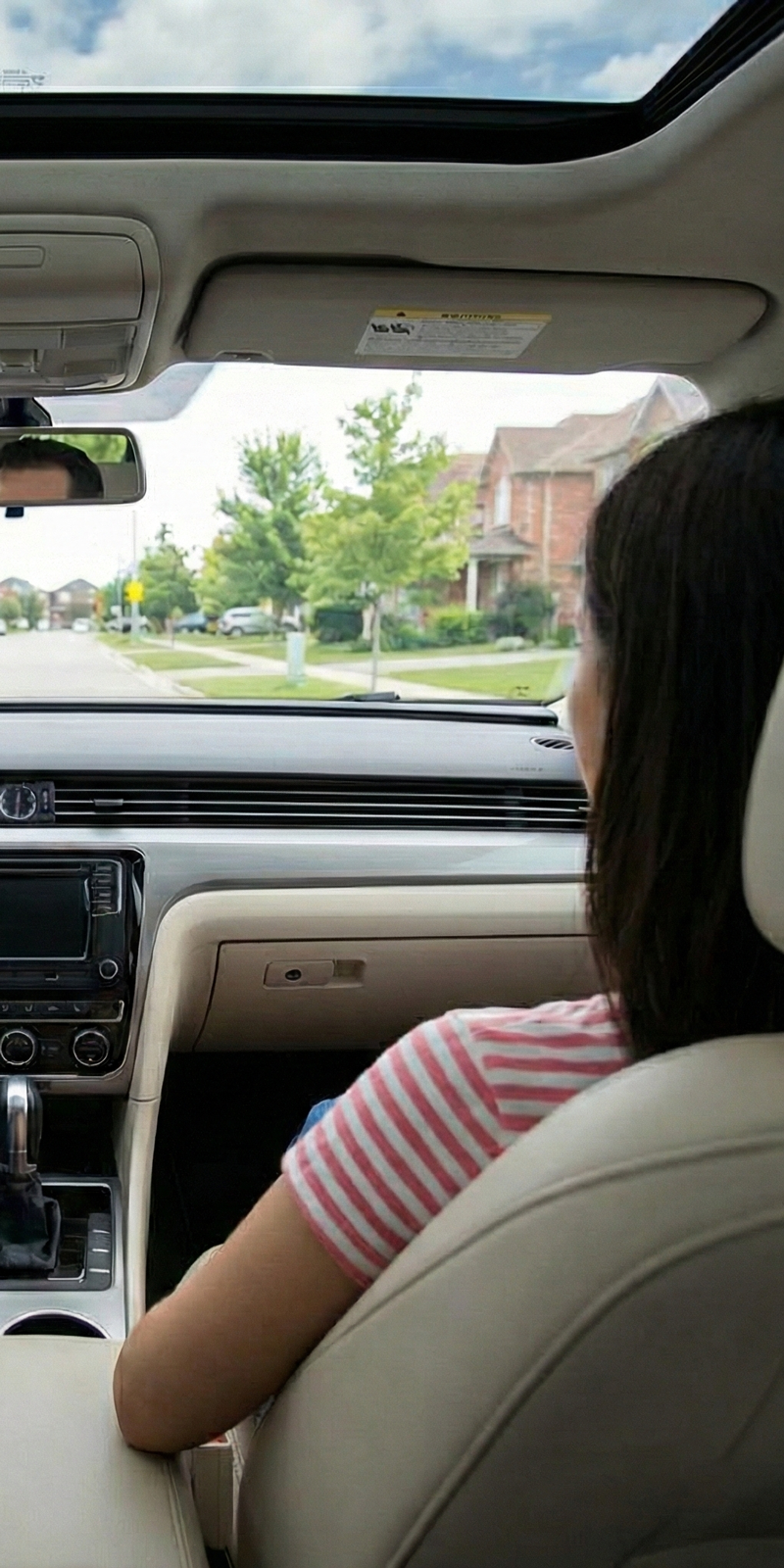 Vehicle driving in suburban neighborhood